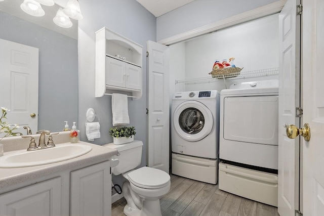 4 Quail Run Dr, Methuen, MA 01844 - bathroom featuring washer and dryer, wood finished floors, toilet, and vanity