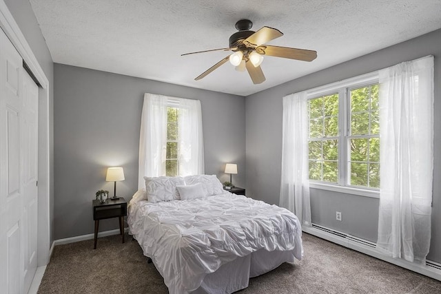 4 Quail Run Dr, Methuen, MA 01844 - carpeted bedroom featuring a baseboard heating unit, a closet, baseboards, and a ceiling fan