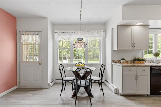 4 Quail Run Dr, Methuen, MA 01844 - dining space with light wood-type flooring, a baseboard radiator, plenty of natural light, a textured ceiling, and baseboards