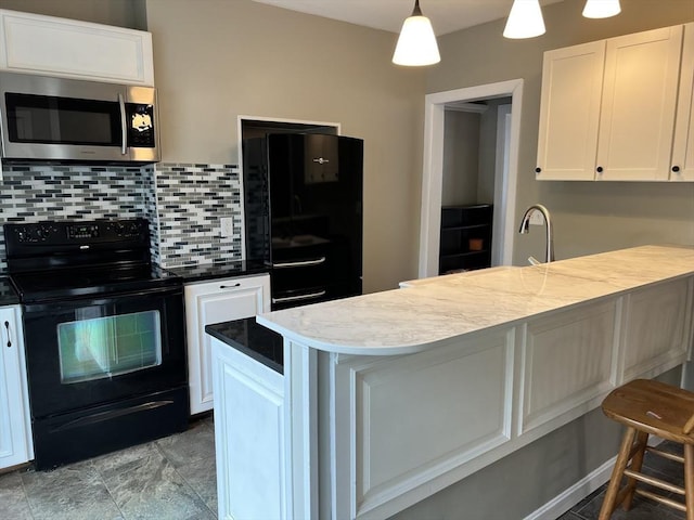 kitchen featuring white cabinetry, backsplash, fridge, black electric range, and decorative light fixtures