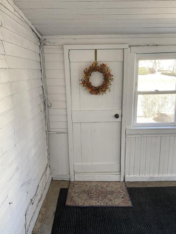 entryway with wooden walls