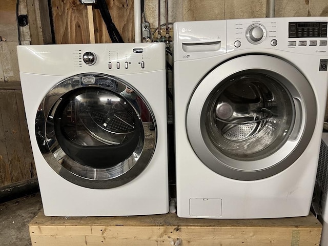 clothes washing area with washing machine and clothes dryer