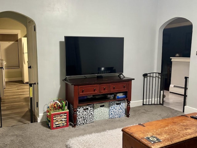 carpeted living room with baseboard heating