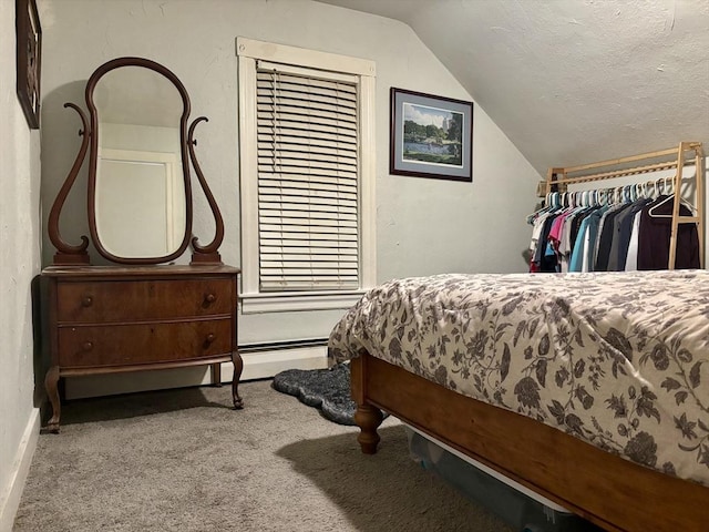 bedroom with carpet flooring, vaulted ceiling, and a textured ceiling