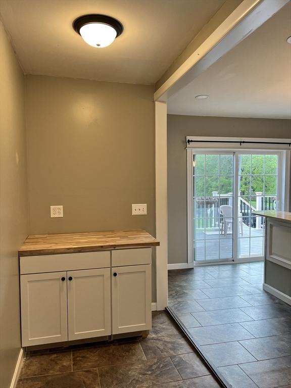 interior space with white cabinetry and butcher block counters