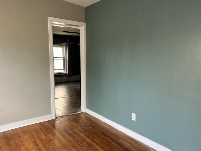 spare room featuring wood-type flooring