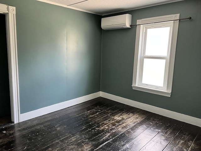 spare room with dark hardwood / wood-style flooring and a wall mounted AC