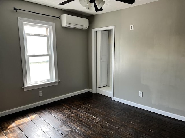 empty room with an AC wall unit, dark wood-type flooring, and ceiling fan