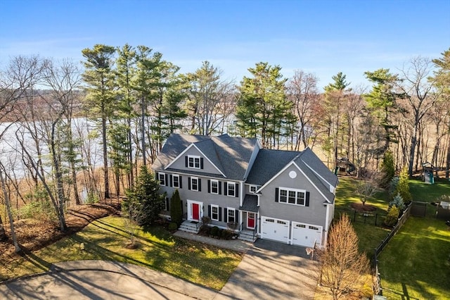95 Gibson Ave, Dedham, MA 02026 - view of front of property featuring a garage, a front lawn, fence, and concrete driveway