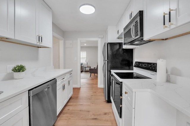 7 Hammond Pond Pkwy Unit 1, Newton, MA 02467 - kitchen featuring appliances with stainless steel finishes, light wood finished floors, white cabinets, and light stone counters