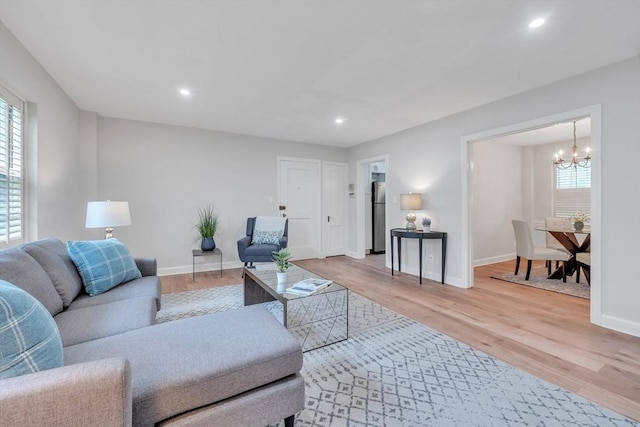 7 Hammond Pond Pkwy Unit 1, Newton, MA 02467 - living room with a chandelier, healthy amount of natural light, light wood-style flooring, baseboards, and recessed lighting