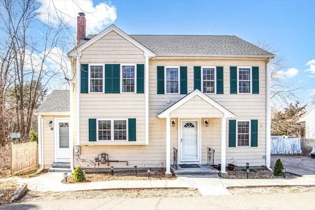 859 Pleasant St, Canton, MA 02021 - view of front facade with entry steps, fence, a shingled roof, and a chimney