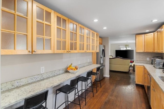 859 Pleasant St, Canton, MA 02021 - kitchen with a kitchen breakfast bar, dark wood-type flooring, tasteful backsplash, appliances with stainless steel finishes, and light stone counters