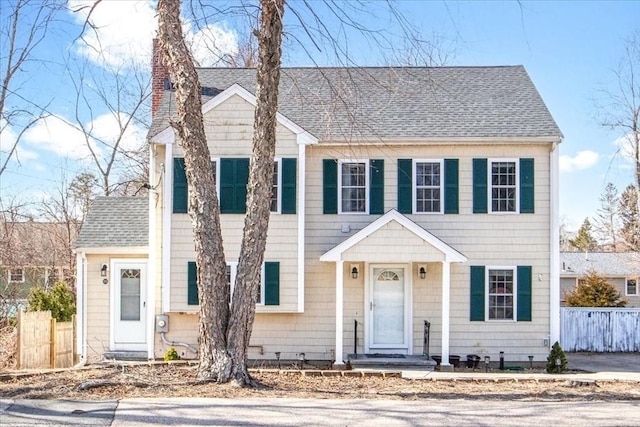 859 Pleasant St, Canton, MA 02021 - view of front of home with roof with shingles, fence, and a chimney