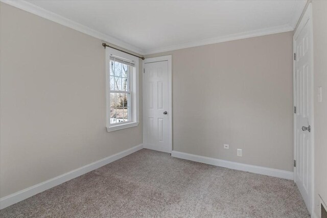 859 Pleasant St, Canton, MA 02021 - unfurnished bedroom with a closet, baseboards, ornamental molding, and carpet floors