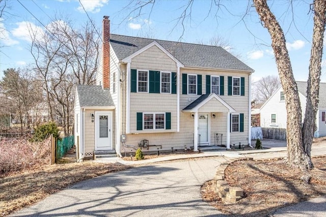 859 Pleasant St, Canton, MA 02021 - view of front of home featuring entry steps, a chimney, a shingled roof, and fence