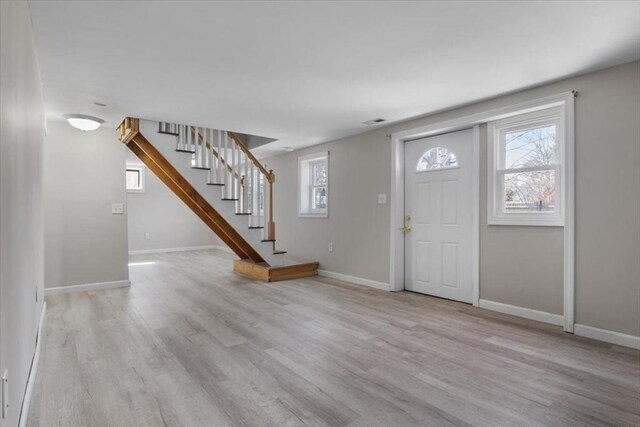 859 Pleasant St, Canton, MA 02021 - entryway featuring a wealth of natural light, stairway, light wood-style flooring, and baseboards