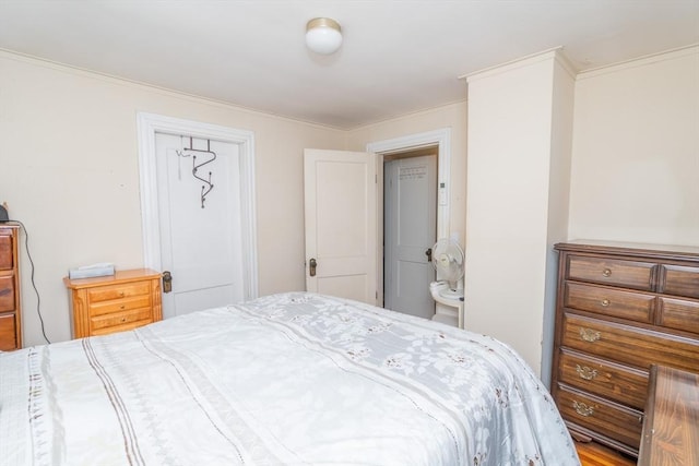 bedroom featuring crown molding and a closet