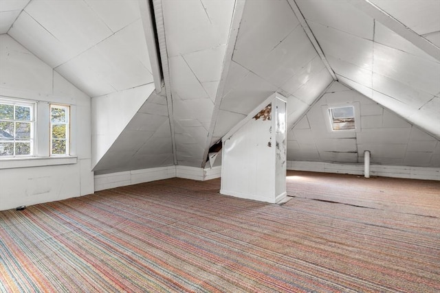 bonus room featuring lofted ceiling and carpet