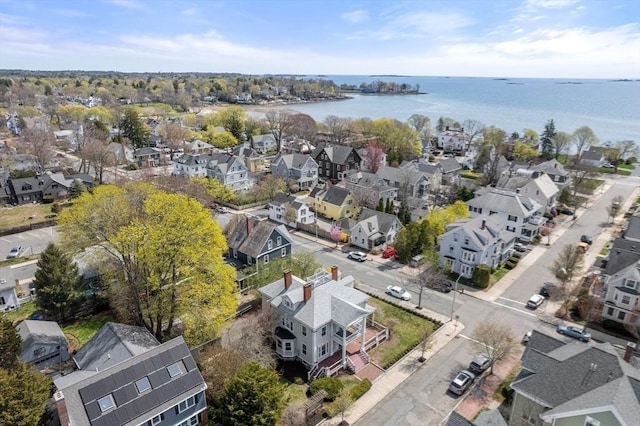 drone / aerial view with a residential view and a water view