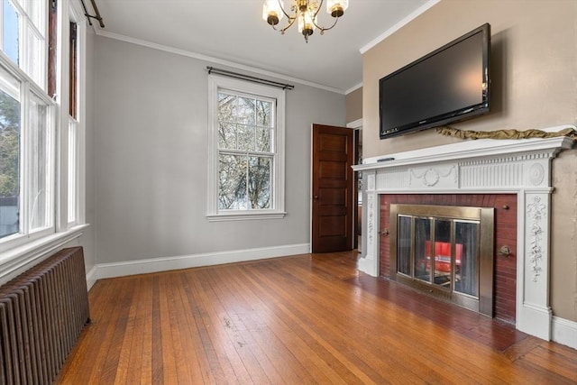 unfurnished living room featuring radiator heating unit, baseboards, an inviting chandelier, and hardwood / wood-style floors