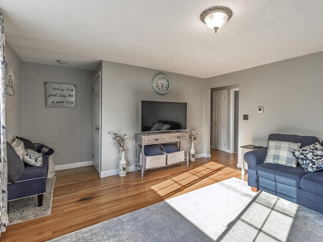 living area with wood finished floors and baseboards