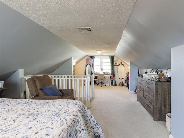 bedroom with lofted ceiling, light colored carpet, and a textured ceiling