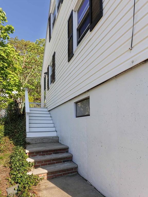 view of side of home with stairway