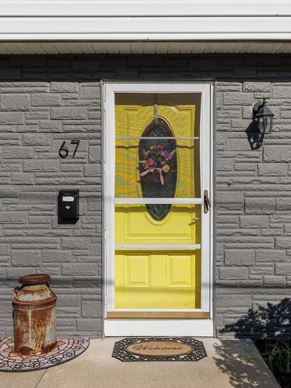 doorway to property featuring stone siding