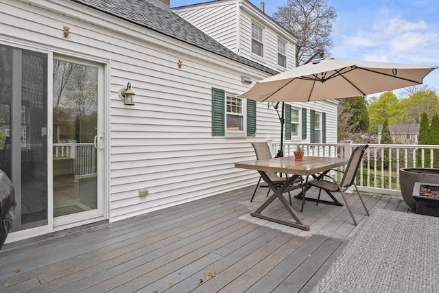 wooden deck with outdoor dining area