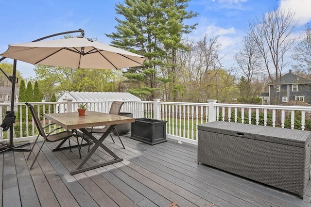 wooden terrace featuring outdoor dining area