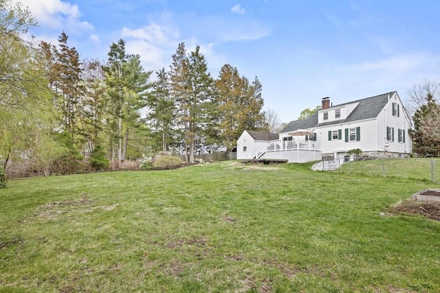 view of yard featuring fence and a wooden deck