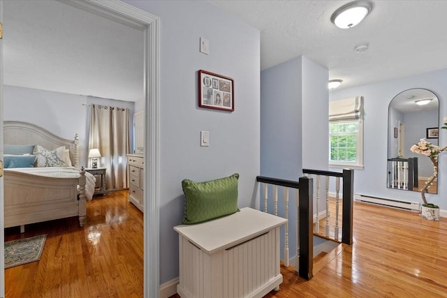 16 Gilbert Way, Millbury, MA 01527 - hall with a baseboard radiator, wood finished floors, an upstairs landing, and arched walkways