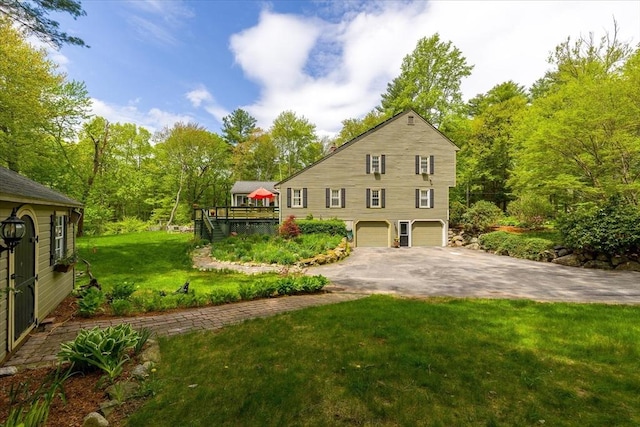 16 Gilbert Way, Millbury, MA 01527 - rear view of property with a garage, asphalt driveway, a yard, and a wooden deck