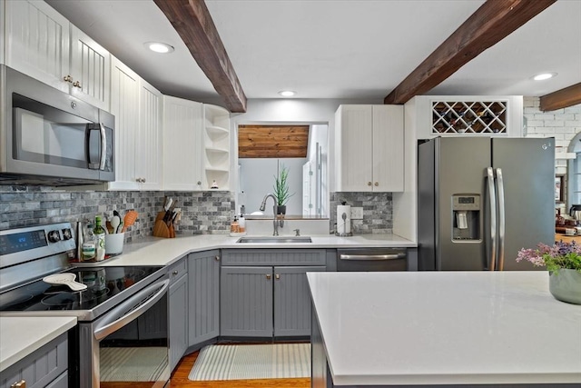 16 Gilbert Way, Millbury, MA 01527 - kitchen with stainless steel appliances, gray cabinetry, a sink, beamed ceiling, and tasteful backsplash