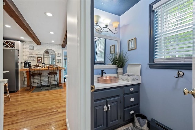16 Gilbert Way, Millbury, MA 01527 - bathroom with wood finished floors, vanity, beam ceiling, recessed lighting, and a baseboard radiator