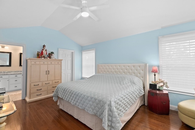 bedroom featuring dark hardwood / wood-style floors, ceiling fan, lofted ceiling, and ensuite bathroom