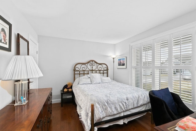 bedroom with dark hardwood / wood-style floors