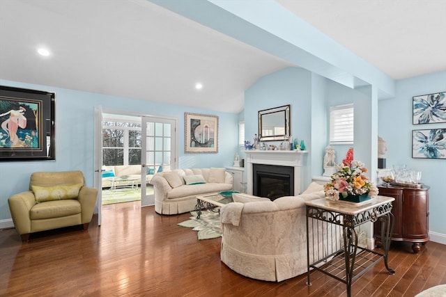 living room featuring dark hardwood / wood-style floors, vaulted ceiling, and plenty of natural light