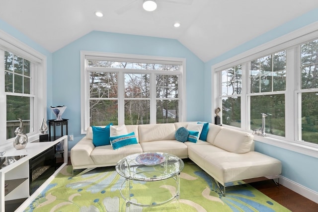 sunroom / solarium featuring ceiling fan, a healthy amount of sunlight, and vaulted ceiling