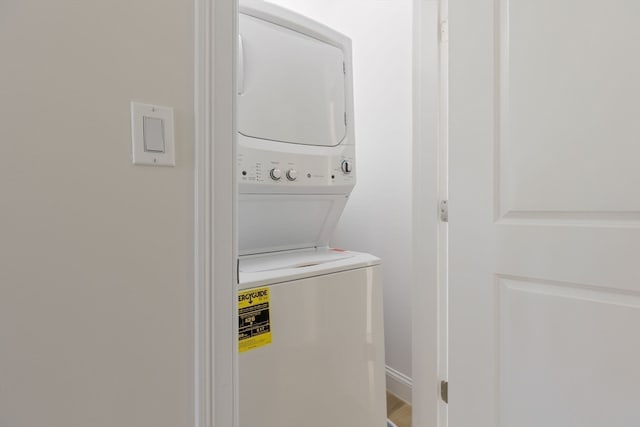 laundry area featuring stacked washer / dryer