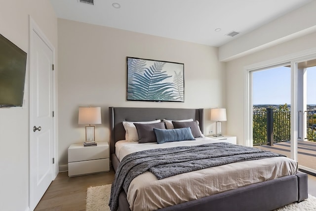 bedroom featuring light hardwood / wood-style floors and access to outside