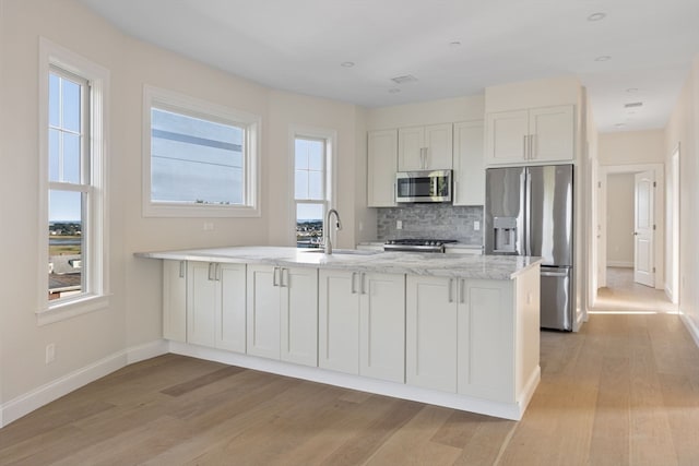 kitchen featuring white cabinets, a healthy amount of sunlight, and appliances with stainless steel finishes