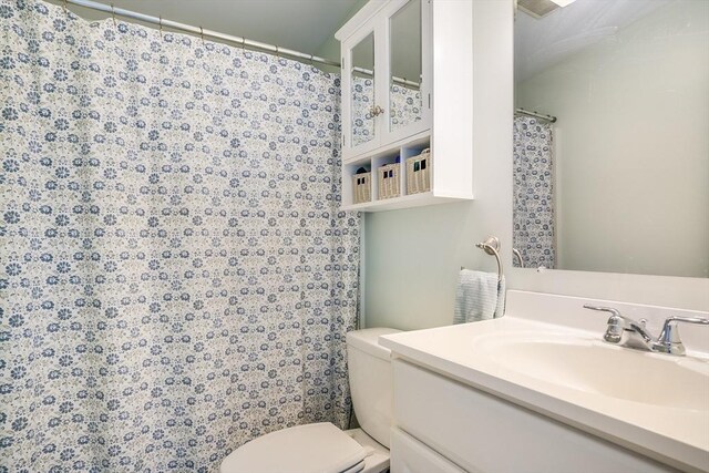 bathroom featuring toilet and vanity