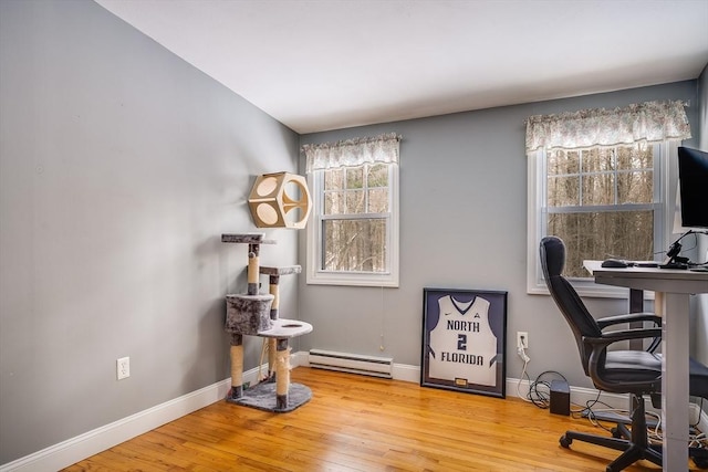 office with baseboards, baseboard heating, and hardwood / wood-style flooring