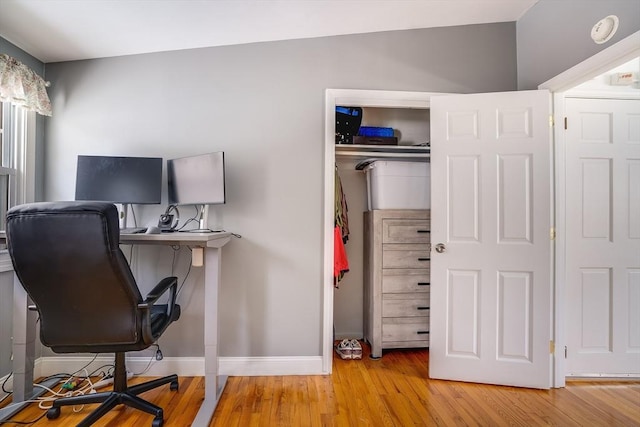 home office featuring light wood-type flooring and baseboards