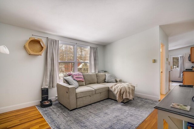 living room with light wood-style flooring and baseboards