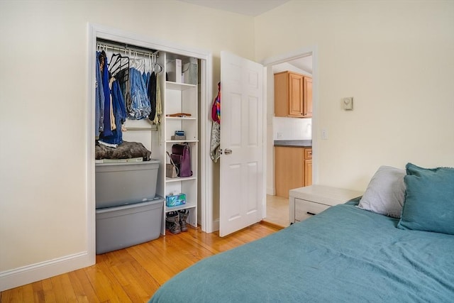 bedroom with a closet and light wood-style flooring