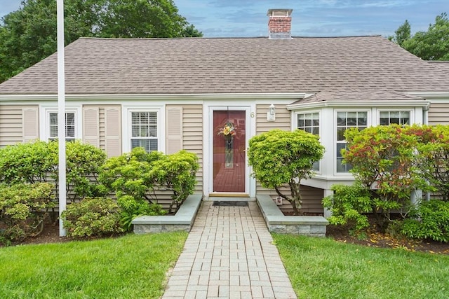 6 Gilbert Rd, Natick, MA 01760 - view of front of house with a shingled roof and a chimney