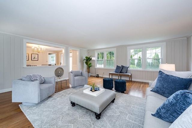 6 Gilbert Rd, Natick, MA 01760 - living area featuring wood finished floors, a chandelier, a decorative wall, and baseboards